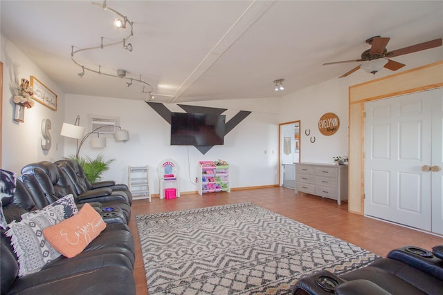 living room featuring a ceiling fan, rail lighting, baseboards, and tile patterned floors