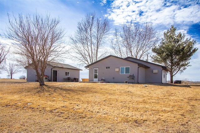 rear view of property with an outbuilding