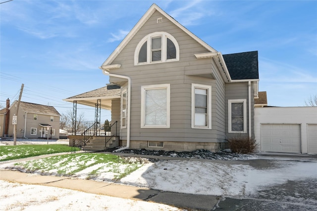 view of front of home featuring covered porch, roof with shingles, and an attached garage