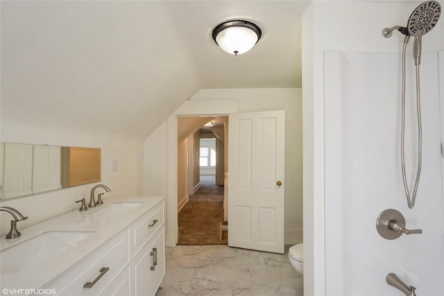 201 E 4th St S, Newton, IA 50208 - bathroom with marble look tiles, vaulted ceiling, double vanity, and shower / tub combination
