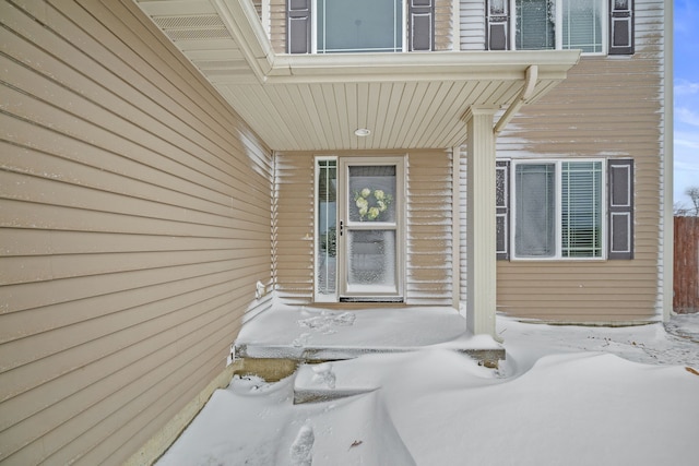 view of snow covered property entrance