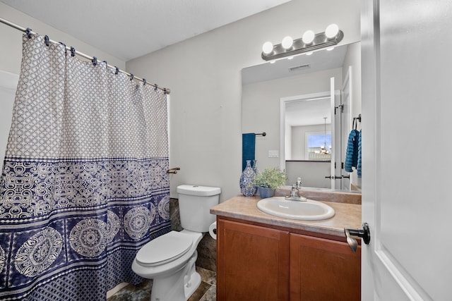 bathroom with visible vents, vanity, and toilet