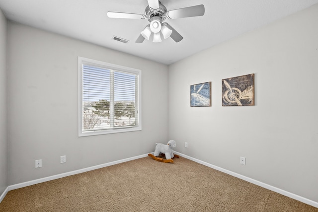 unfurnished room with a ceiling fan, carpet flooring, visible vents, and baseboards