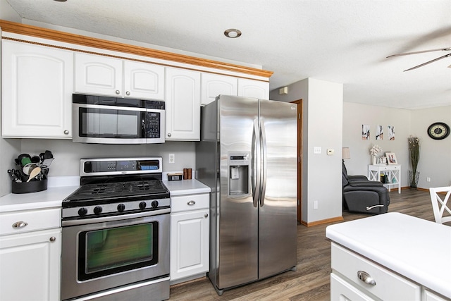 kitchen with open floor plan, light countertops, appliances with stainless steel finishes, and white cabinetry