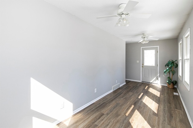 entrance foyer featuring visible vents, baseboards, and wood finished floors