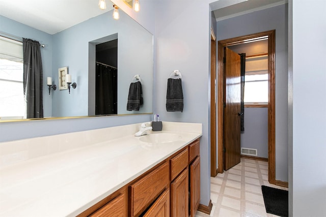 bathroom featuring visible vents, vanity, and tile patterned floors