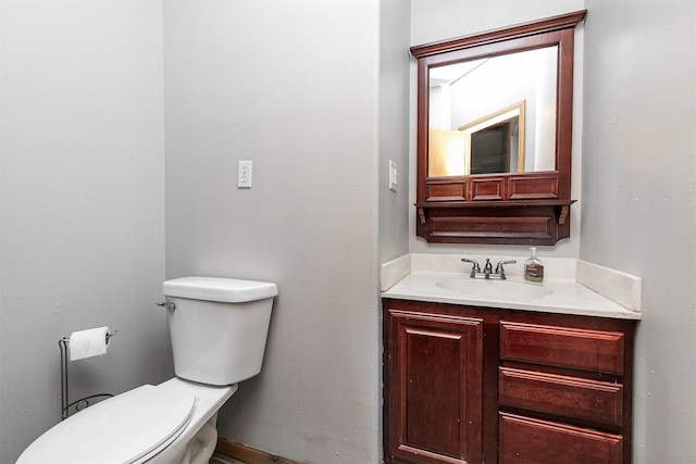 half bathroom with toilet and vanity