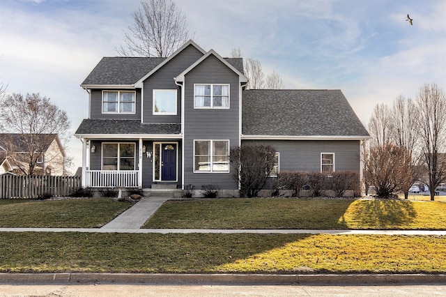 traditional-style house with roof with shingles, covered porch, a front lawn, and fence