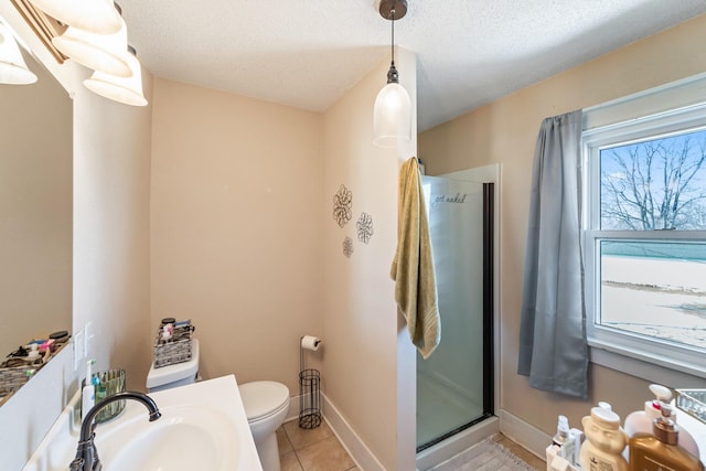 full bath featuring a textured ceiling, a stall shower, tile patterned flooring, and toilet