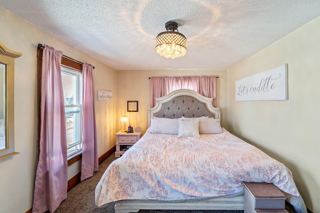 carpeted bedroom with multiple windows, a textured ceiling, baseboards, and an inviting chandelier