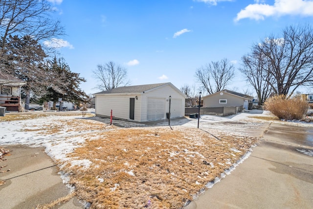 exterior space with an outbuilding and a detached garage