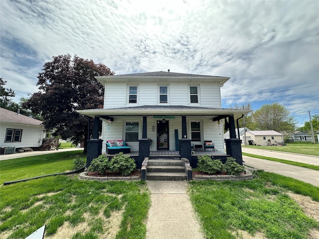 502 E Douglas St, Knoxville, IA 50138 - traditional style home featuring a porch, a front lawn, and central AC unit