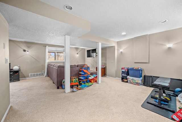 game room with carpet floors, visible vents, a textured ceiling, and baseboards