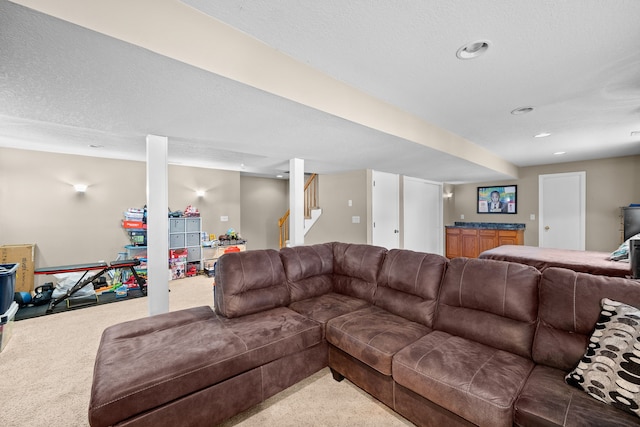 living area with stairs, a textured ceiling, carpet, and recessed lighting