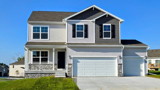 view of front of property with covered porch, a front lawn, concrete driveway, and roof with shingles