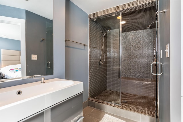 ensuite bathroom with a stall shower, ensuite bath, vanity, and tile patterned floors