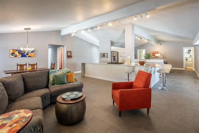 living room with lofted ceiling, baseboards, rail lighting, and an inviting chandelier