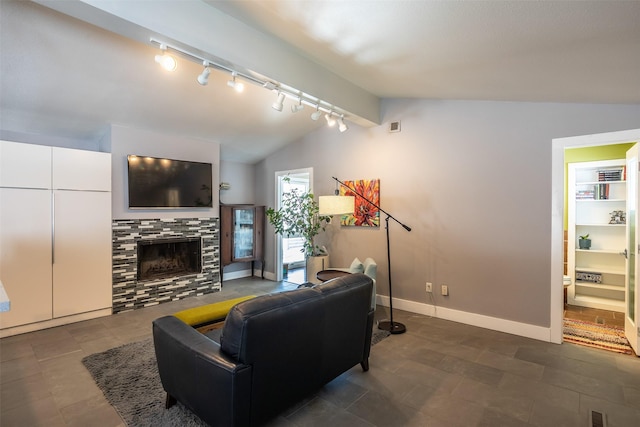 living area featuring lofted ceiling, visible vents, a fireplace, and baseboards