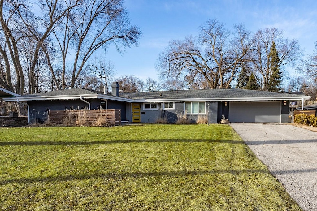 1503 Lewis Ave, Des Moines, IA 50315 - ranch-style home with aphalt driveway, a chimney, and a front lawn