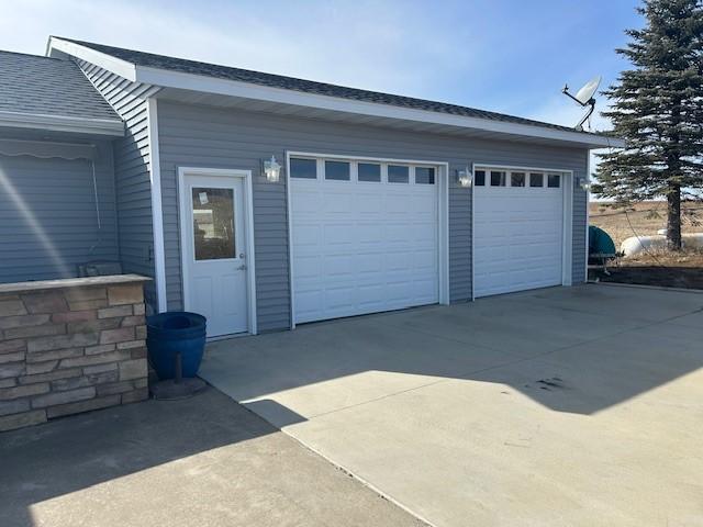 garage with concrete driveway