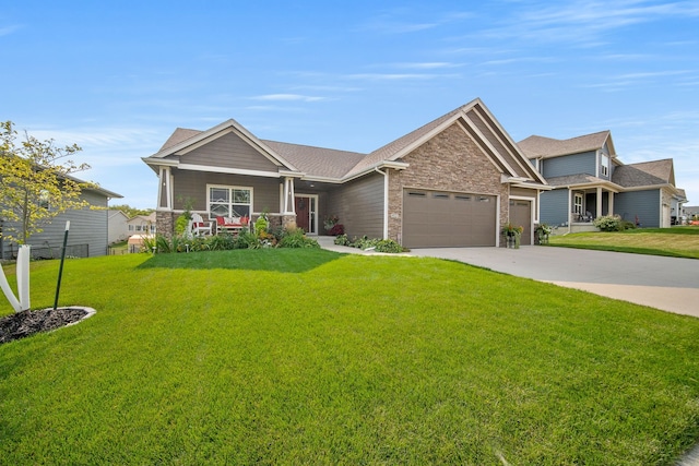 view of front of home featuring brick siding, a porch, concrete driveway, an attached garage, and a front yard