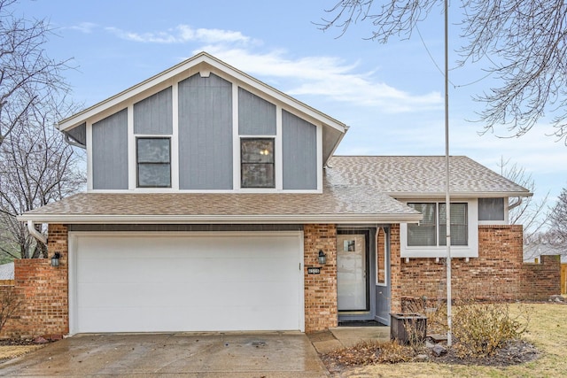 tri-level home with an attached garage, driveway, roof with shingles, and brick siding