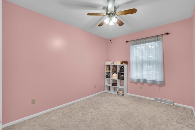 unfurnished room featuring a ceiling fan, carpet, visible vents, and baseboards