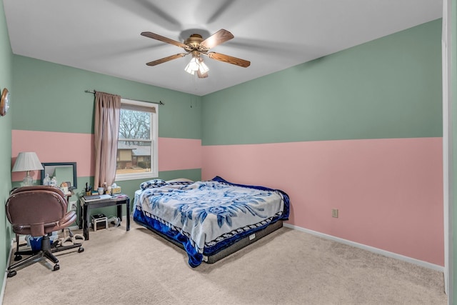 carpeted bedroom with ceiling fan and baseboards