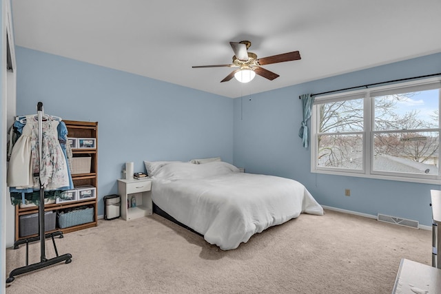 bedroom with ceiling fan, carpet flooring, visible vents, and baseboards