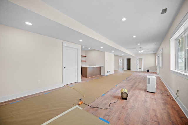 unfurnished living room with baseboards, a ceiling fan, and recessed lighting