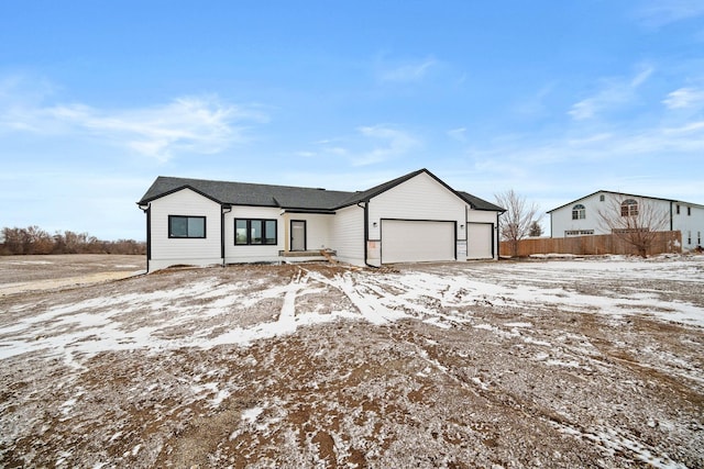 view of front of home with a garage and fence