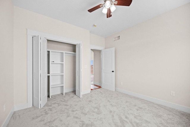 unfurnished bedroom with visible vents, baseboards, ceiling fan, carpet floors, and a closet