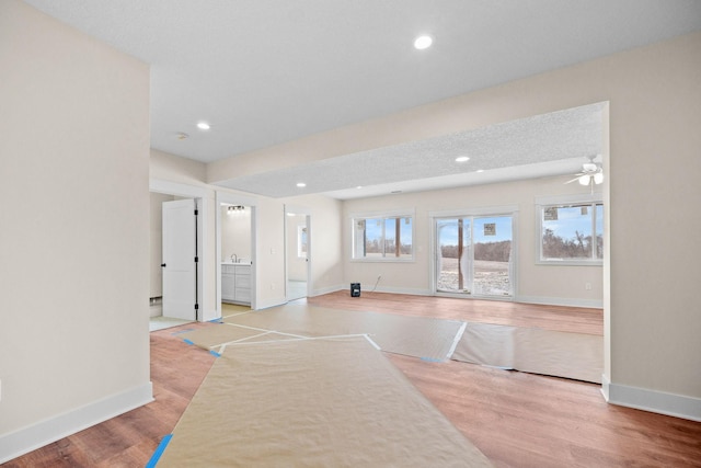 spare room featuring recessed lighting, light wood-style flooring, and baseboards