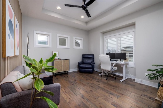 office featuring recessed lighting, baseboards, a tray ceiling, and hardwood / wood-style flooring