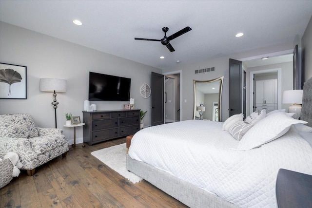 bedroom with hardwood / wood-style floors, a ceiling fan, baseboards, visible vents, and recessed lighting