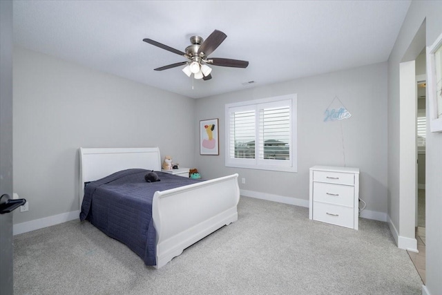 bedroom featuring visible vents, a ceiling fan, carpet, and baseboards