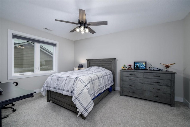 bedroom featuring light carpet, visible vents, a ceiling fan, and baseboards