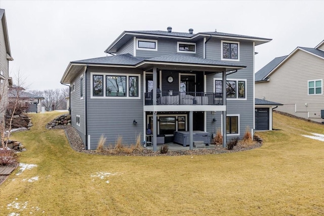 rear view of house with a patio area, a balcony, a lawn, and a hot tub