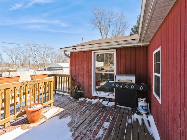 wooden terrace with a grill and fence