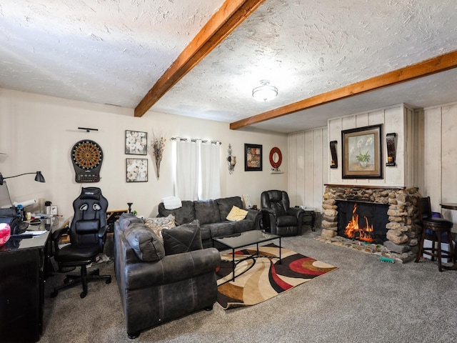 carpeted living room with beam ceiling, a textured ceiling, and a stone fireplace