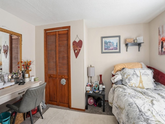 bedroom featuring a closet, light carpet, and a textured ceiling