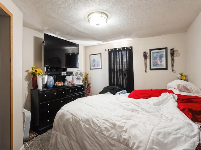 bedroom with carpet flooring and a textured ceiling