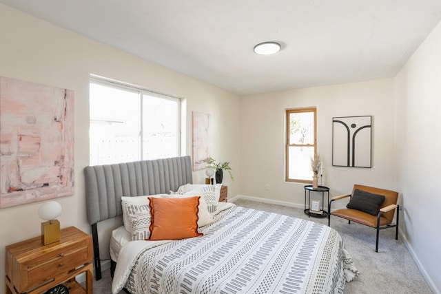 bedroom with light carpet and baseboards
