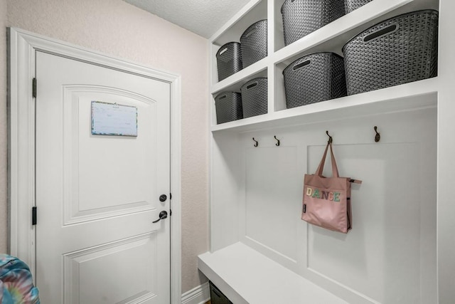 mudroom with a textured ceiling