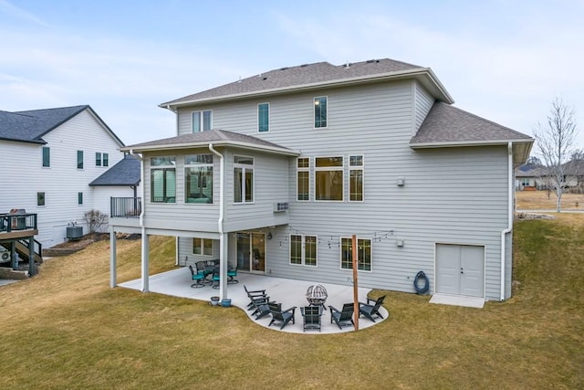 rear view of property with a yard, a patio, central AC unit, and roof with shingles