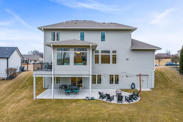 back of house featuring a yard, cooling unit, roof with shingles, and a patio