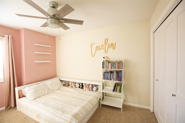 carpeted bedroom featuring ceiling fan, baseboards, and a closet