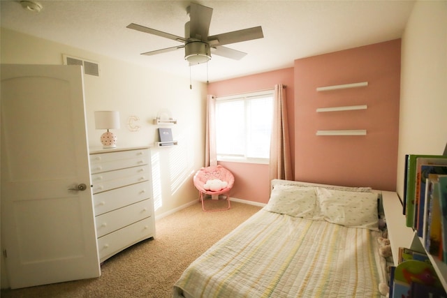 bedroom with a ceiling fan, carpet flooring, visible vents, and baseboards