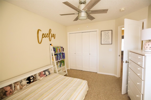 bedroom with light carpet, a closet, a ceiling fan, and baseboards