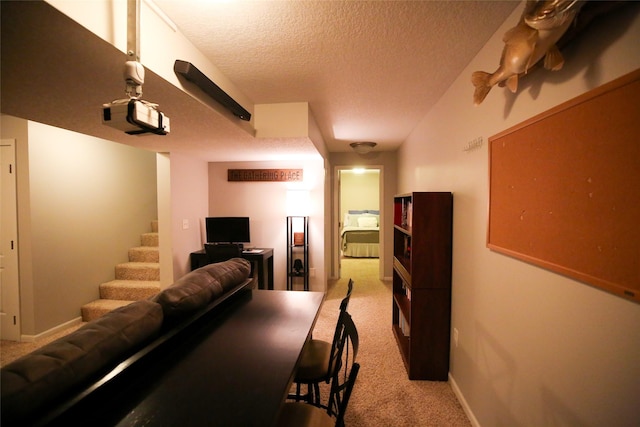 living area with light carpet, stairway, a textured ceiling, and baseboards